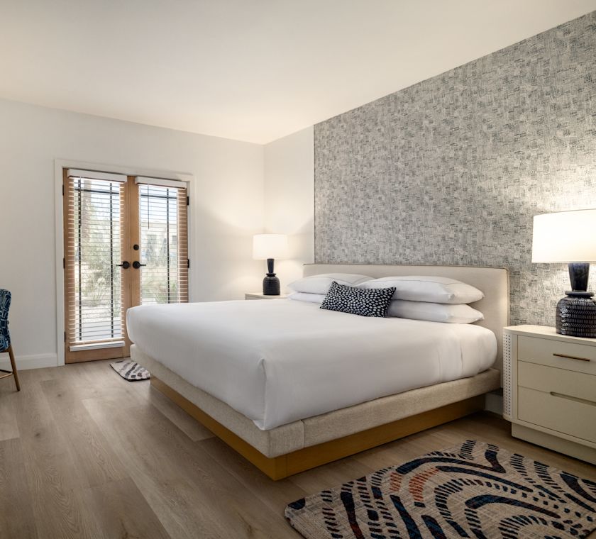 Serene guest suite with bed, work desk, and TV