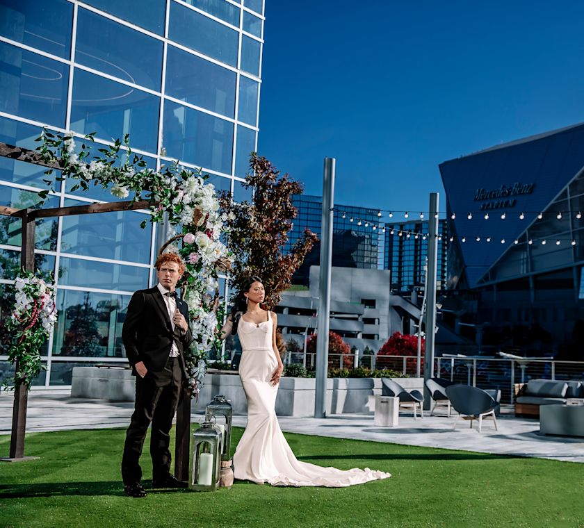Bride and groom in front of building