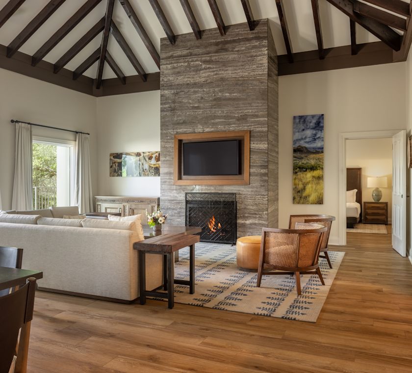 Guest living room with sofa, chairs, dining table, TV and fireplace