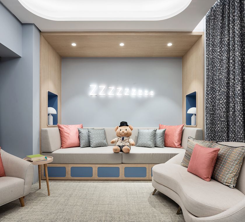 Kids club seating area with teddy on sofa chairs