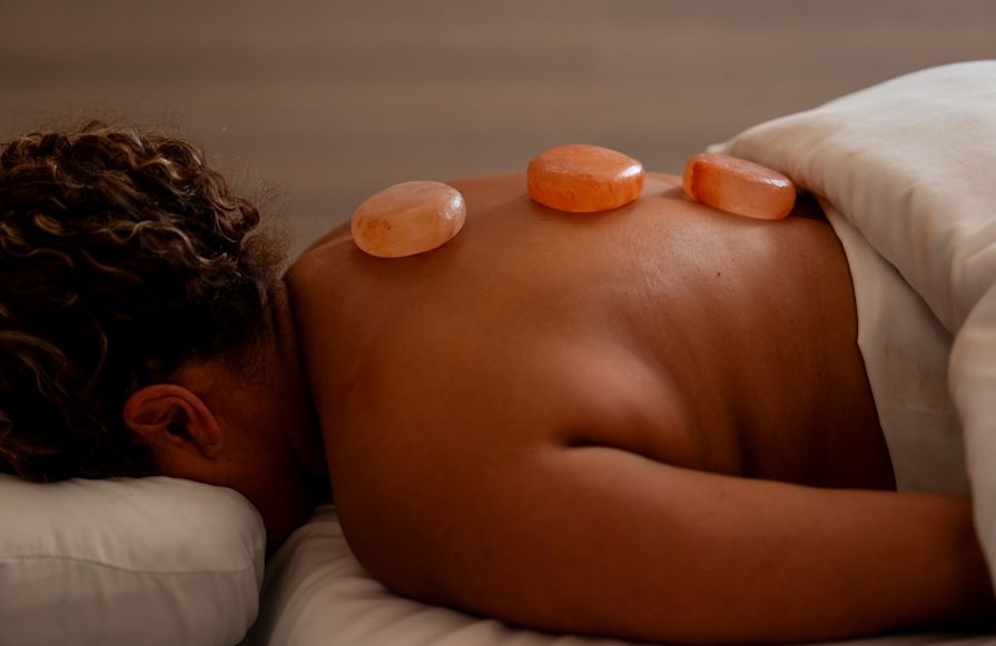 Woman receiving a hot stone massage-transition