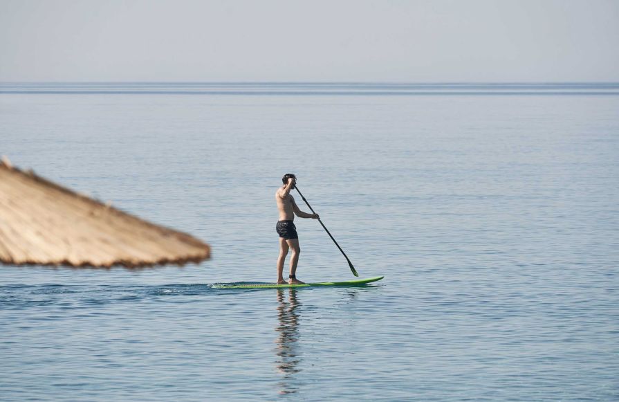 Man paddle boarding in the sea-transition