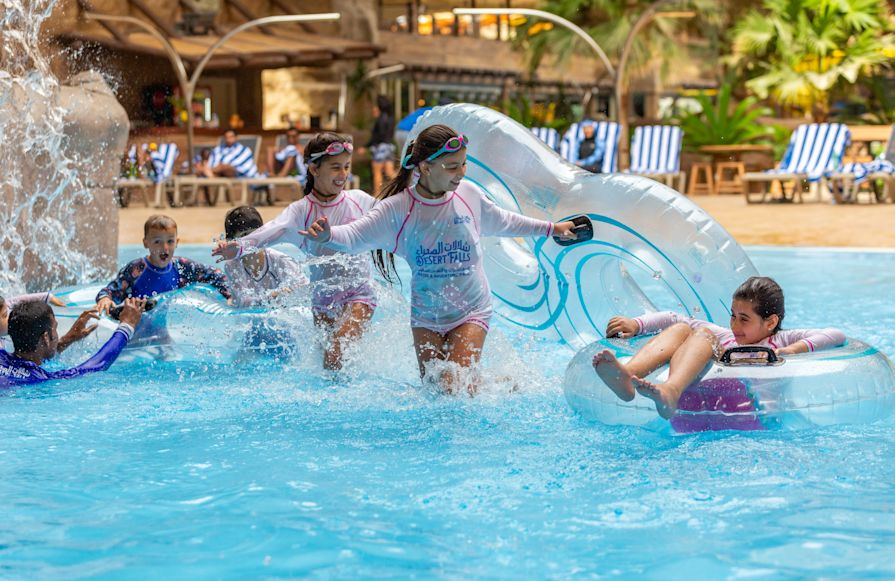 kids with pool floats at outdoor waterpark-transition