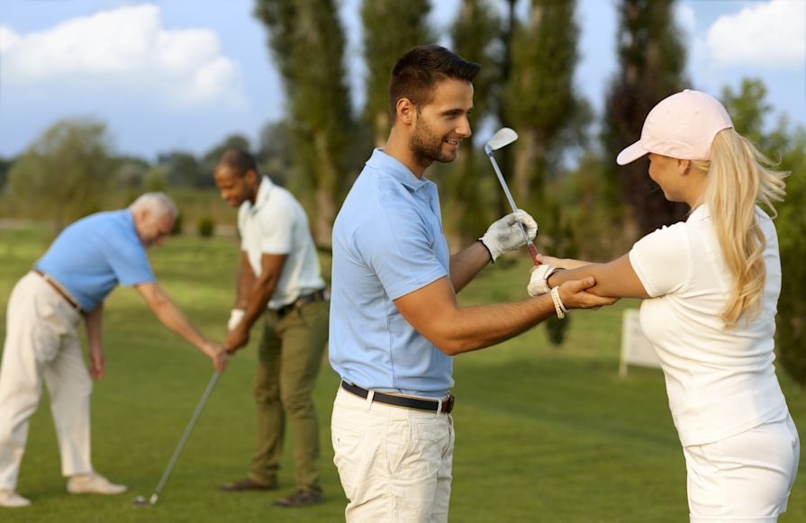 Golfers receiving golf lessons.-transition