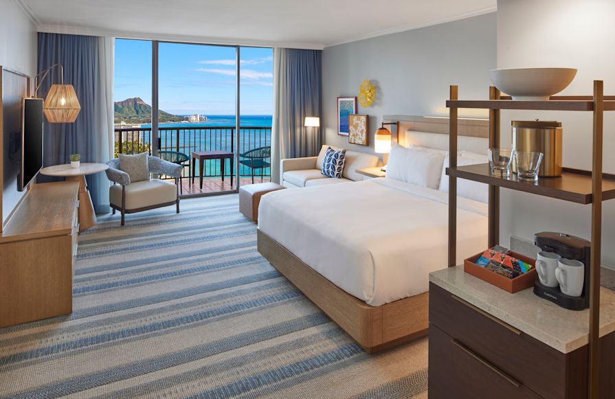 Large Bed, Sofa and Sitting Area in a Guest Room with Balcony and Water View-transition