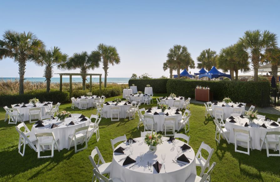 Round tables setup outside on the lawn for a wedding reception-transition