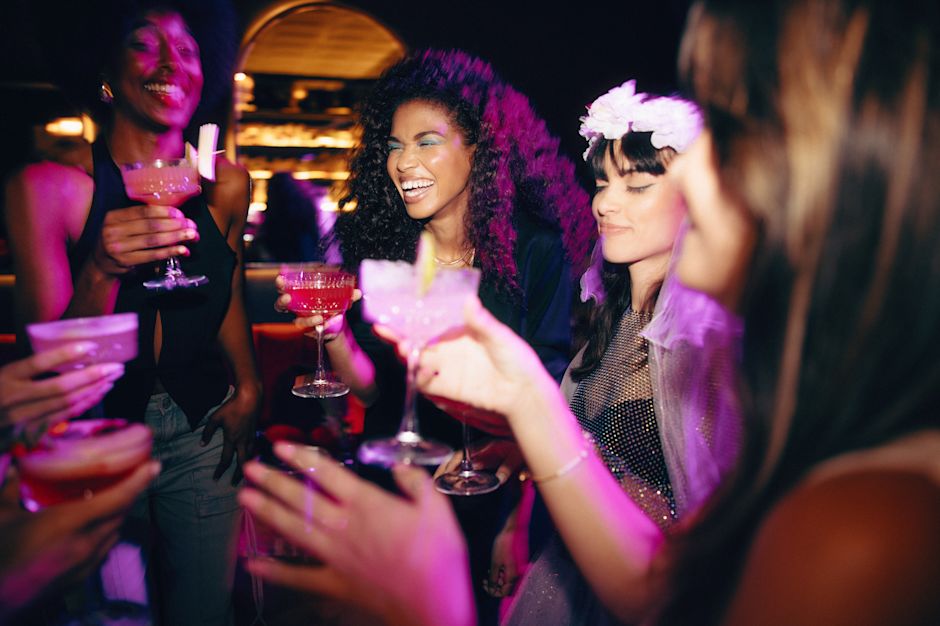 Young women celebrating a bachelorette party and sharing drinks