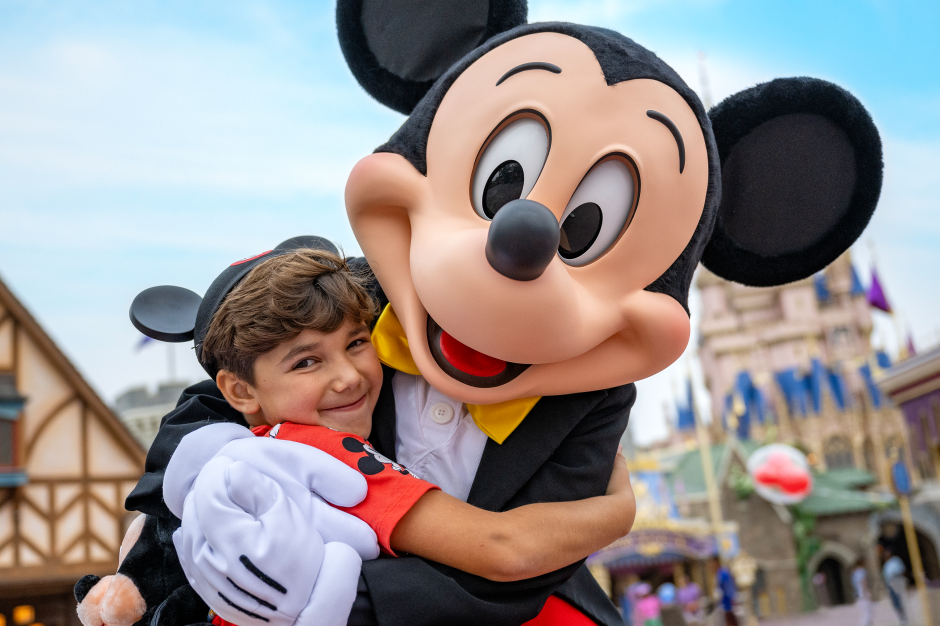 boy hugging mickey mouse