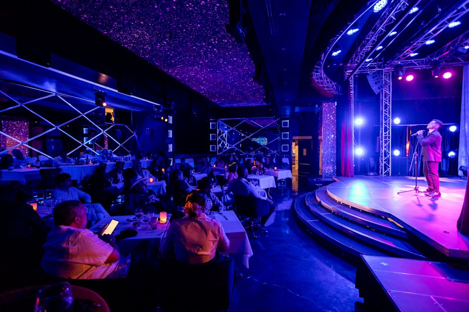 Performer speaking at Emotions Dinner Theater