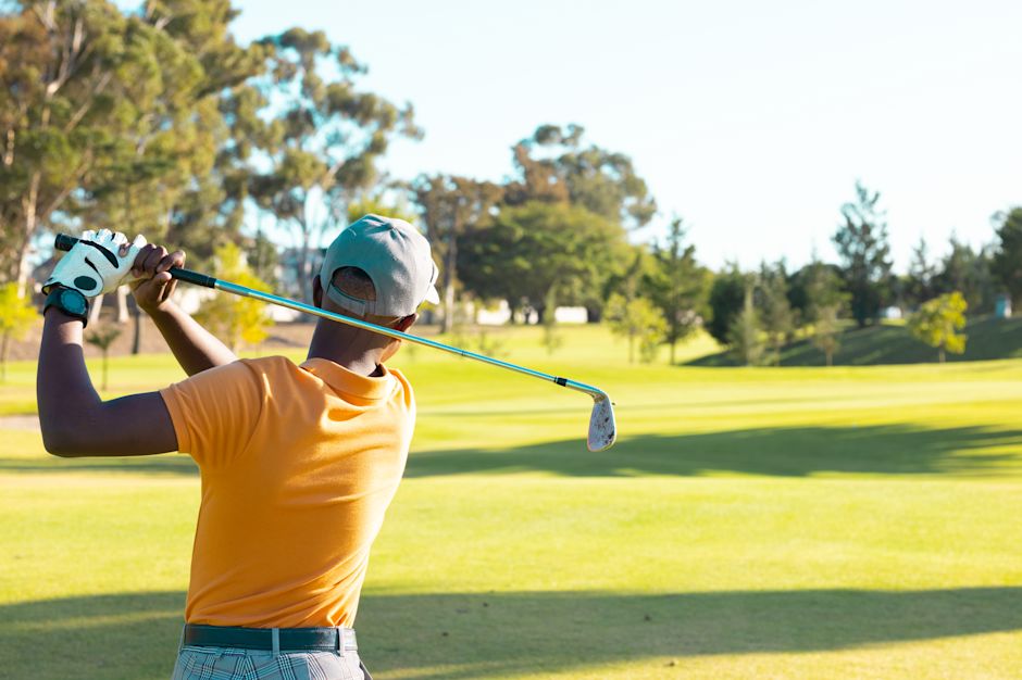 man swinging golf club