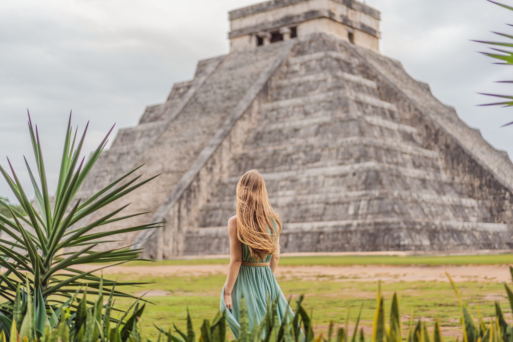 Person standing in front of Mayan ruins
