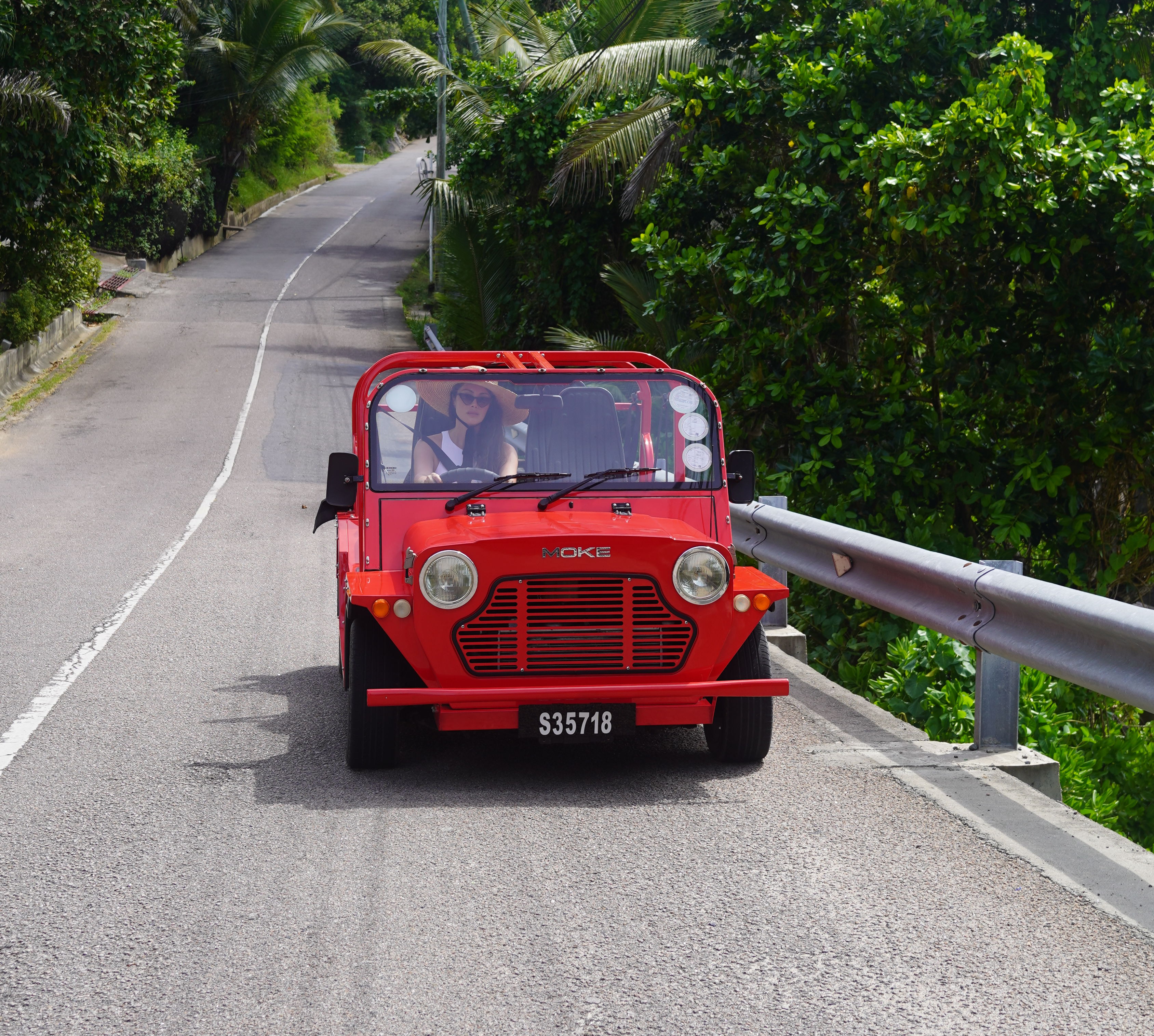 woman driving a red vintage car