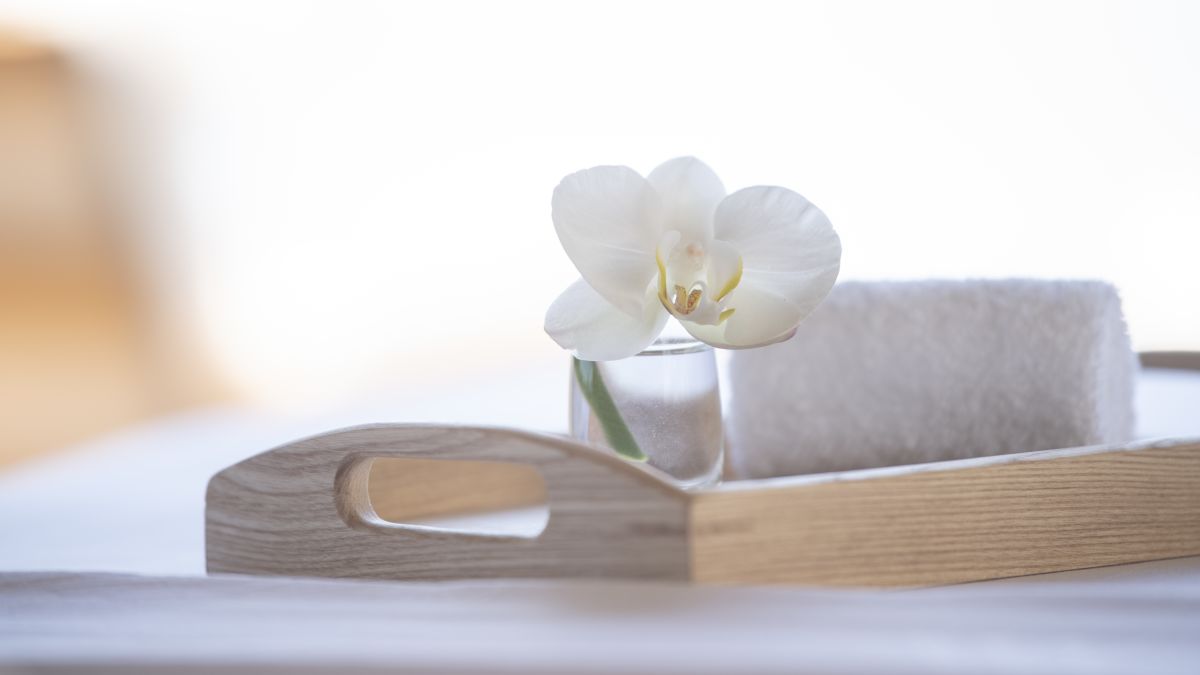 Wooden tray with spa towel and flower