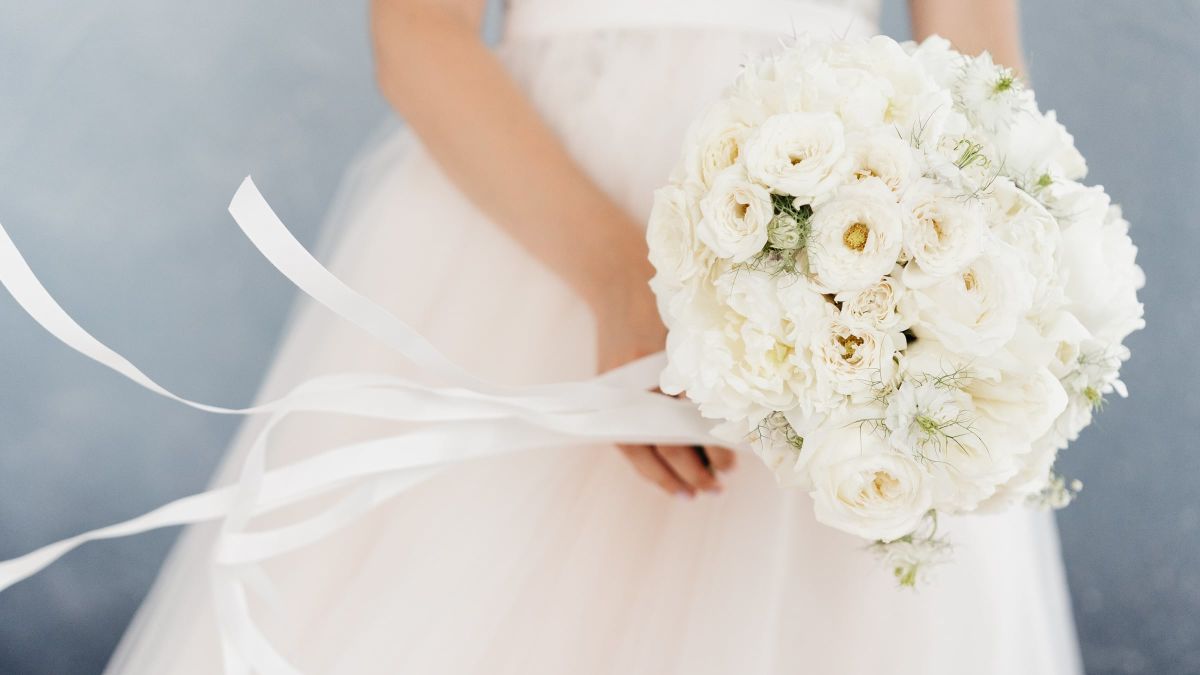 Woman holding bouquet of white flowers