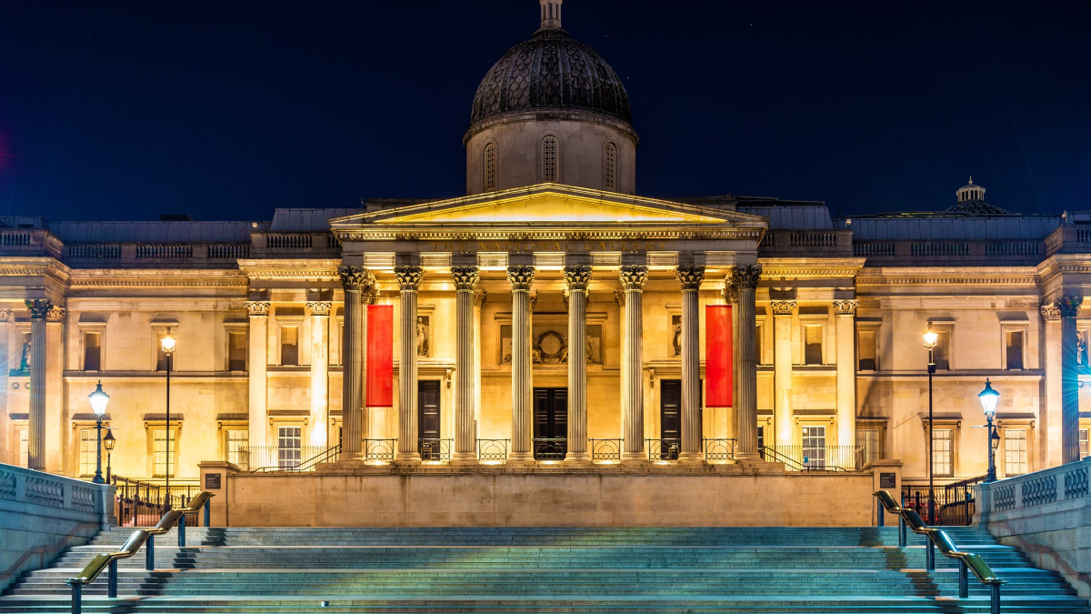 Exterior view of the National Gallery at night.