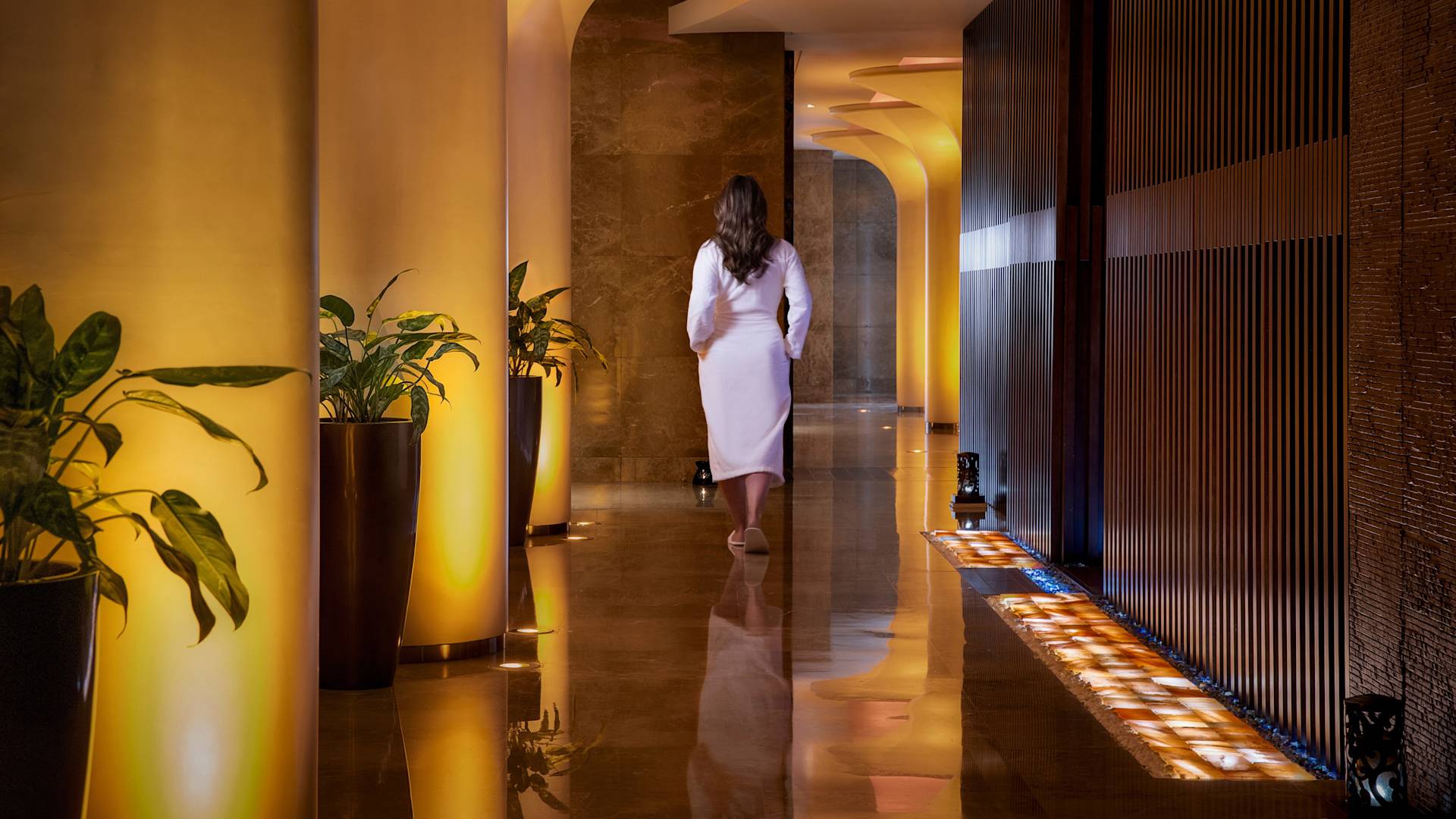 woman walking along hallway