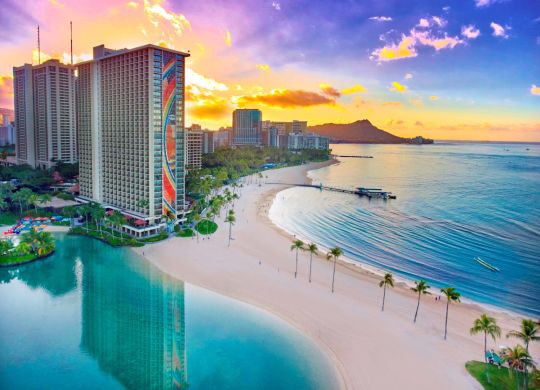 Resort Exterior view of Hotel with beach and ocean at sunset