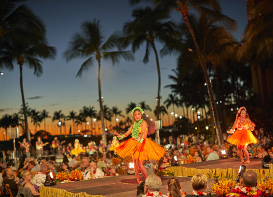 Luau event with dancers and people watching