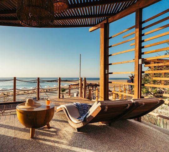 Outdoor Bungalow Enclave reclined seats with view of ocean
