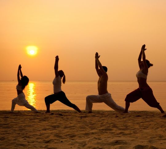 Yoga on the beach at sunset