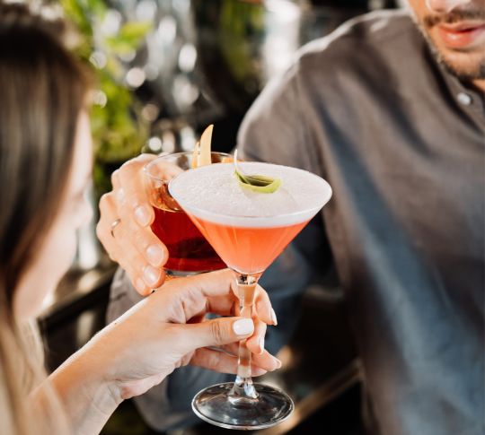 People holding cocktails