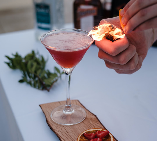 Cocktail in a martini glass with smoked herbs