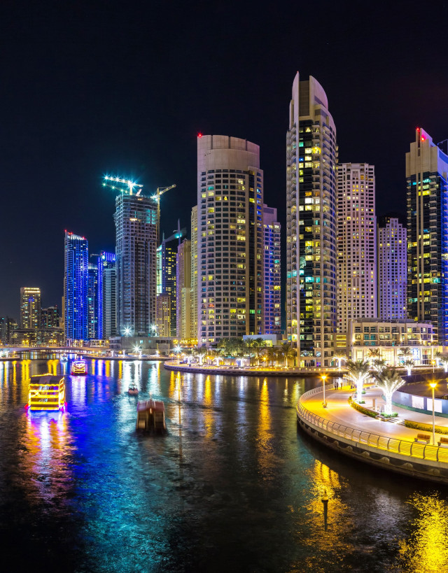 Dubai buildings reflecting in water at night