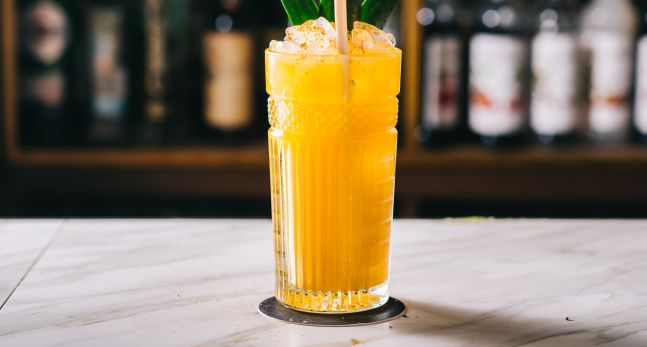 Tropical cocktail with leaf garnish