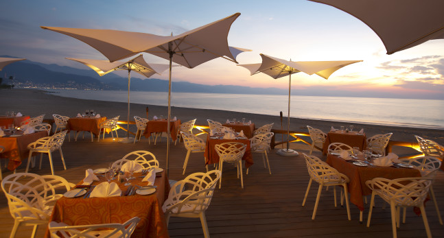 Sea Fire All Day Restaurant outdoor seating at dusk
