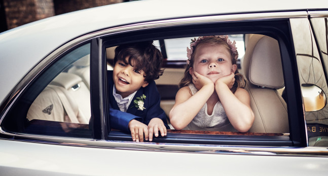 Two children in a wedding car.