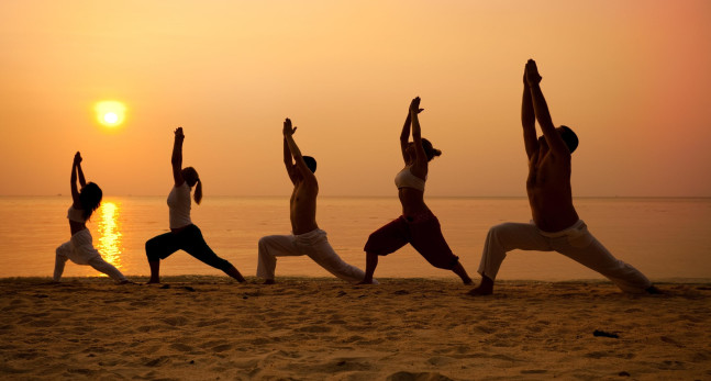Yoga on the beach at sunset