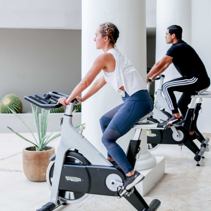 Fitness Center couple on Cycle machines