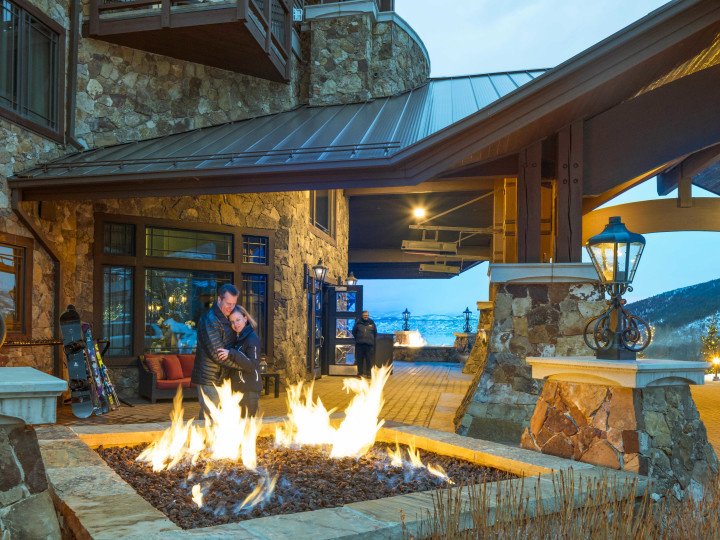 View of outdoor firepit and couple in background