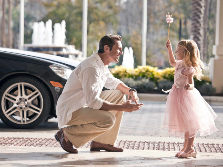 Father with daughter dressed as princess outside