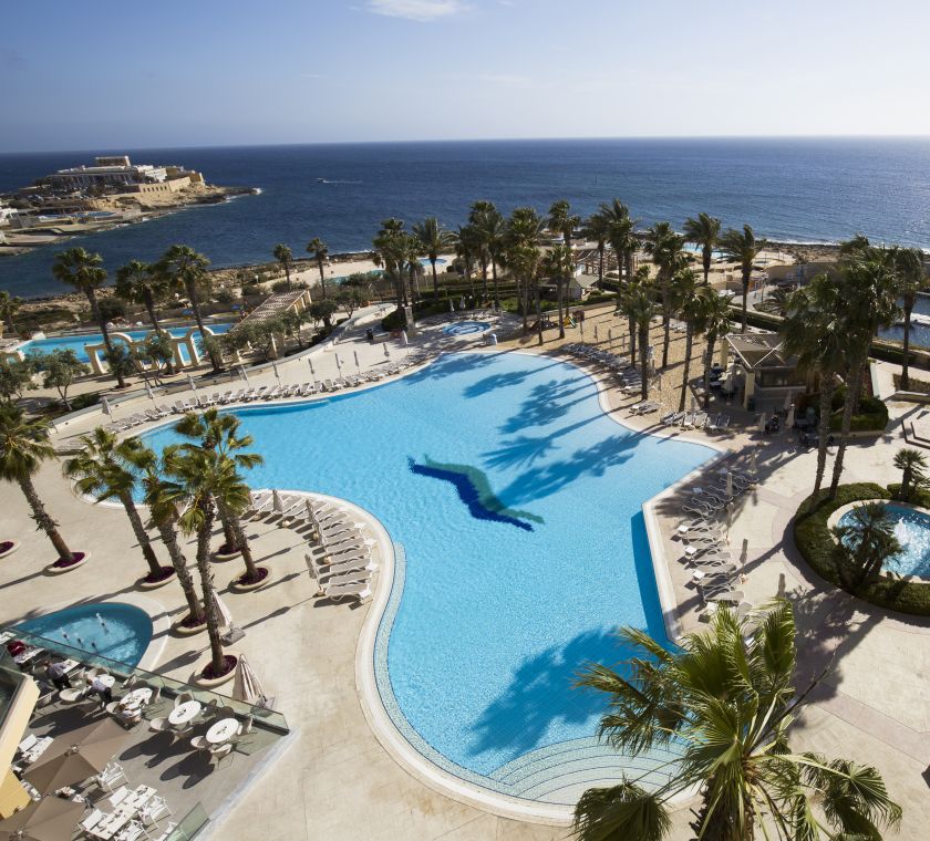 Aerial view of outdoor pool, palm trees and water view