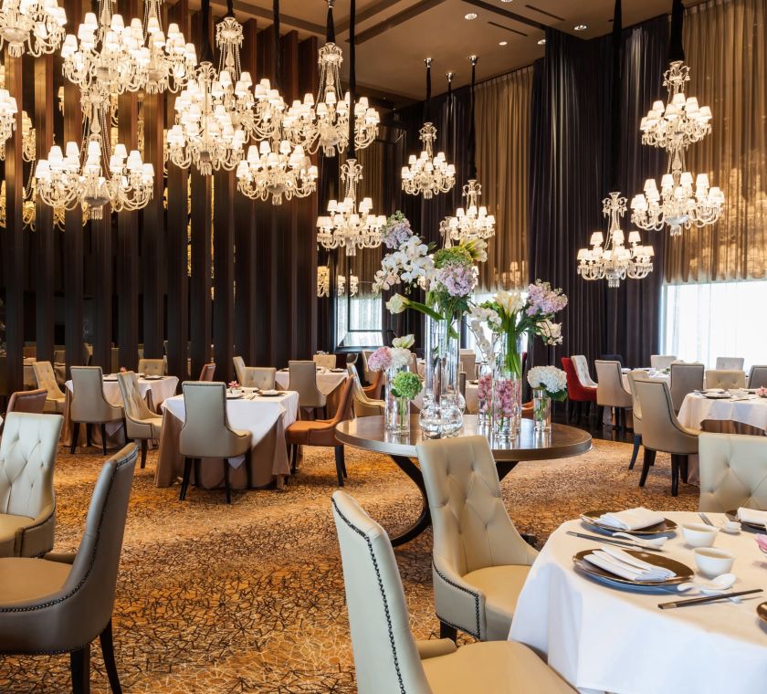 Elegant restaurant with chandeliers and a warm feel.