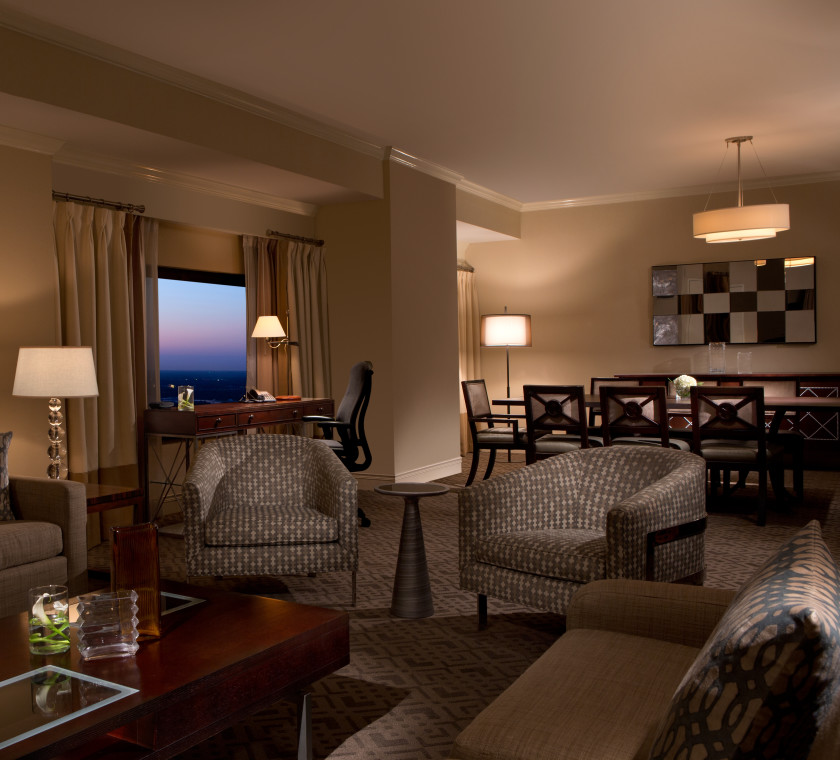 Presidential Suite with couches, chairs, a coffee table, and a dining table and chairs
