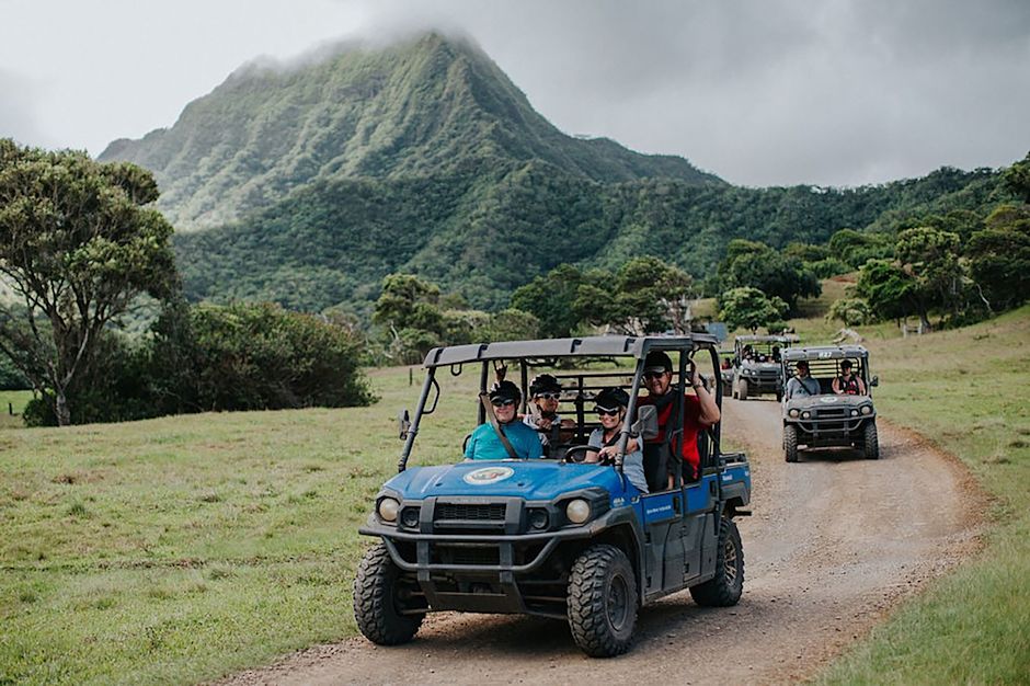 People driving in off-road vehicle on island excursion