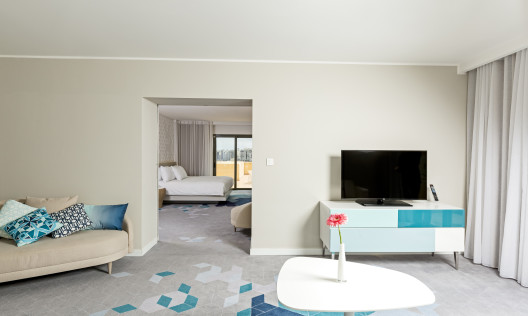 Panorama suite lounge area and tv, bedroom entrance, 1 king bed